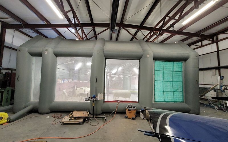Aircraft wing spar inside inflatable paint booth during primer application